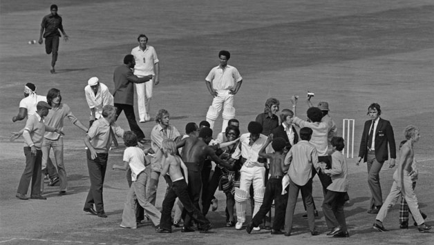 Spectators invade the pitch to congratulate West Indies batsman Bernard Julien on his century © Getty Images
