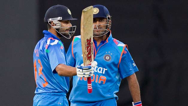 Virat-Kohli-(L)-of-India-celebrates-his-half-century-(50-runs)-with-team-mate-and-captain-MS-Dhoni-during-the-fifth-and-f