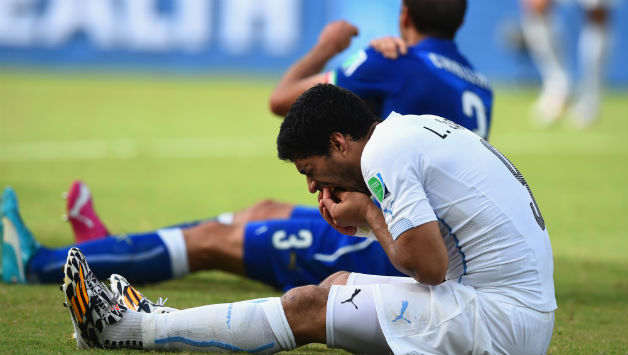 Luis Suarez and defender Giorgio Chiellini lie on the ground after the biting incident © Getty Images