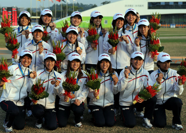 Japanese women cricketers pose with their Bronze medals which they won in 2010 © AFP