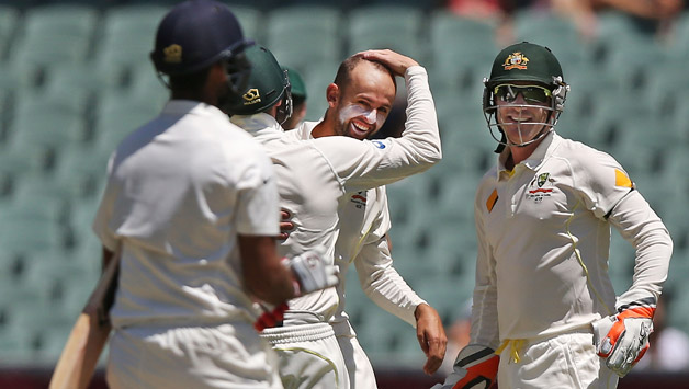 Australian fielders gather around Nathan Lyon as he celebrates a wicket © Getty Images