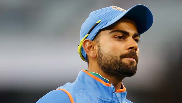 Virat-Kohli-of-India-points-to-the-India-logo-on-his-clothing-as-he-gestures-to-fans-3