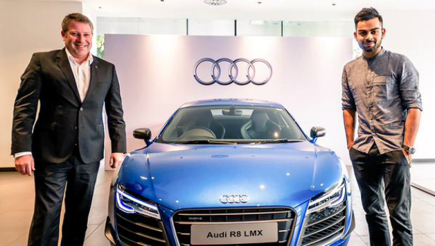 Virat Kohli (right) standing next to his latest possession. Photo Courtesy: Audi India via Twitter.