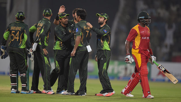 Hamilton Masakadza (right) was dismissed for an impressive 73 by Shoaib Malik after being caught by Hammad Azam © AFP