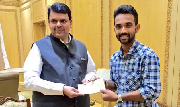 Maharashtra Chief Minister Devendra Fadnavis accepting the donation from Ajinkya Rahane. Photo Courtesy Twitter