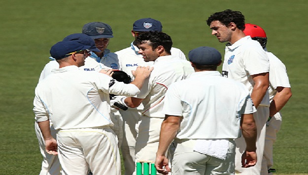 NSW and SA players gather around Callum Ferguson