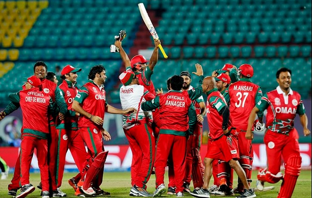 Oman celebrate their historic win over Ireland on Wednesday night. Photo courtesy: PA Images & @RyanK_Bailey on Twitter