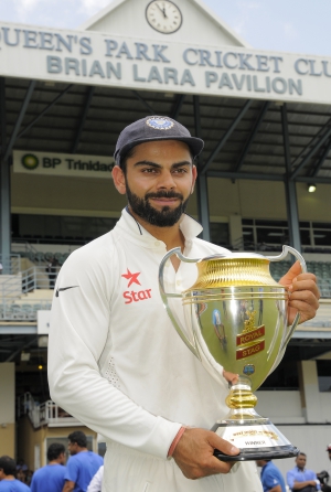 Virat Kohli poses with the trophy after India's series win in West Indies © AFP
