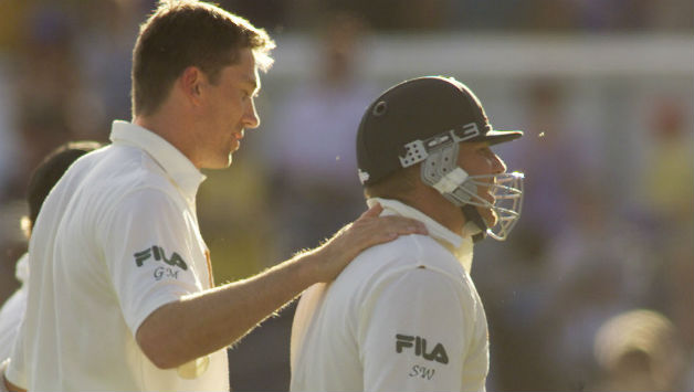 A dejected Shane Warne walks back after being dismissed for 99, consoled by Glenn McGrath © Getty Images