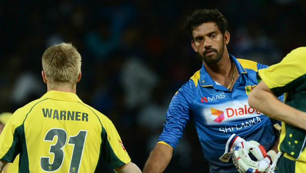 Sachithra Senanayake (right) congratulates David Warner after Australia's thumping win on Tuesday © AFP