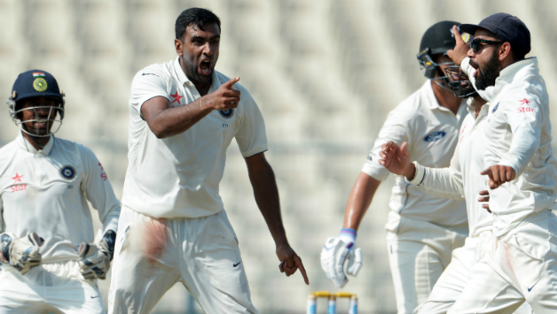 Ravichandran Ashwin(C) and Virat Kohli celebrate with teammates after the wicket of Ross Taylor during the 4th day of the 2nd Test between India and New Zealand
