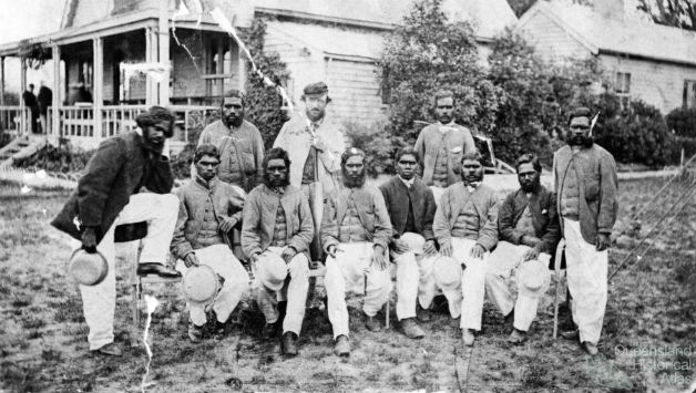 A group of Australian Aboriginal cricketers at MCG (some records claim it was taken at Albert Club, Redfern). Photo courtesy: Wikimedia Commons. Back: Tarpot, Tom Wills, Johnny Mullagh. Front: King Cole (leg on chair), Jellico, Peter, Red Cap, Harry Rose, Bullocky, Johnny Cuzens, Dick-a-Dick (standing).