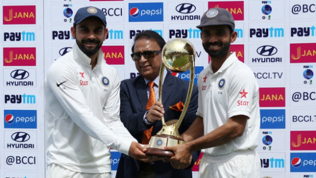 Sunil Gavaskar handing Border-Gavaskar Trophy to Virat Kohli and Ajinkya Rahane © IANS