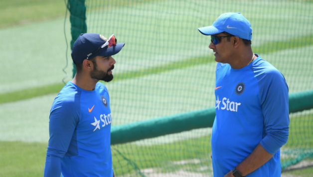 Virat Kohli and Anil Kumble in a serious conversation during the training © AFP